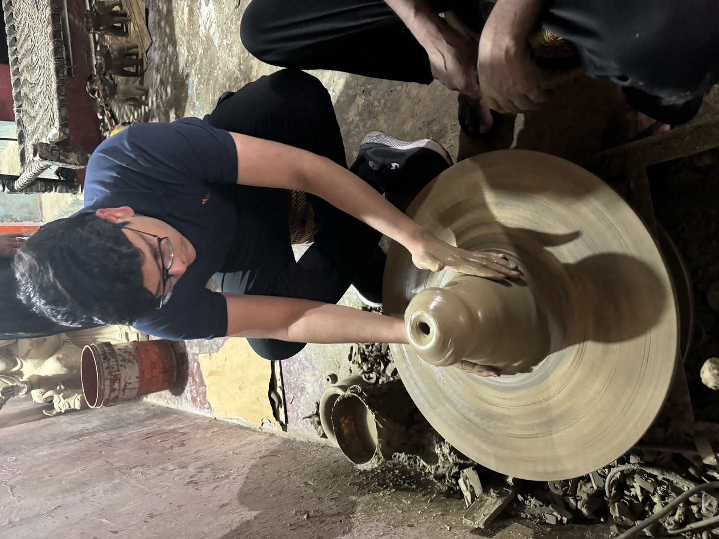 Local artisan crafting a clay pot